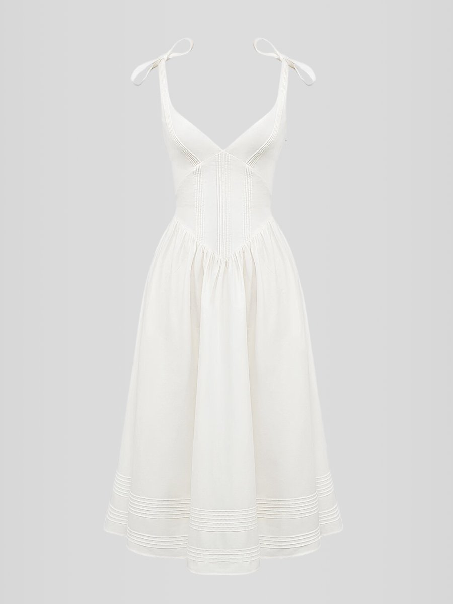Vestido midi blanco sin mangas con corset estructurado y ballenas internas. Diseño elegante con bolsillos discretos y ajuste entallado.