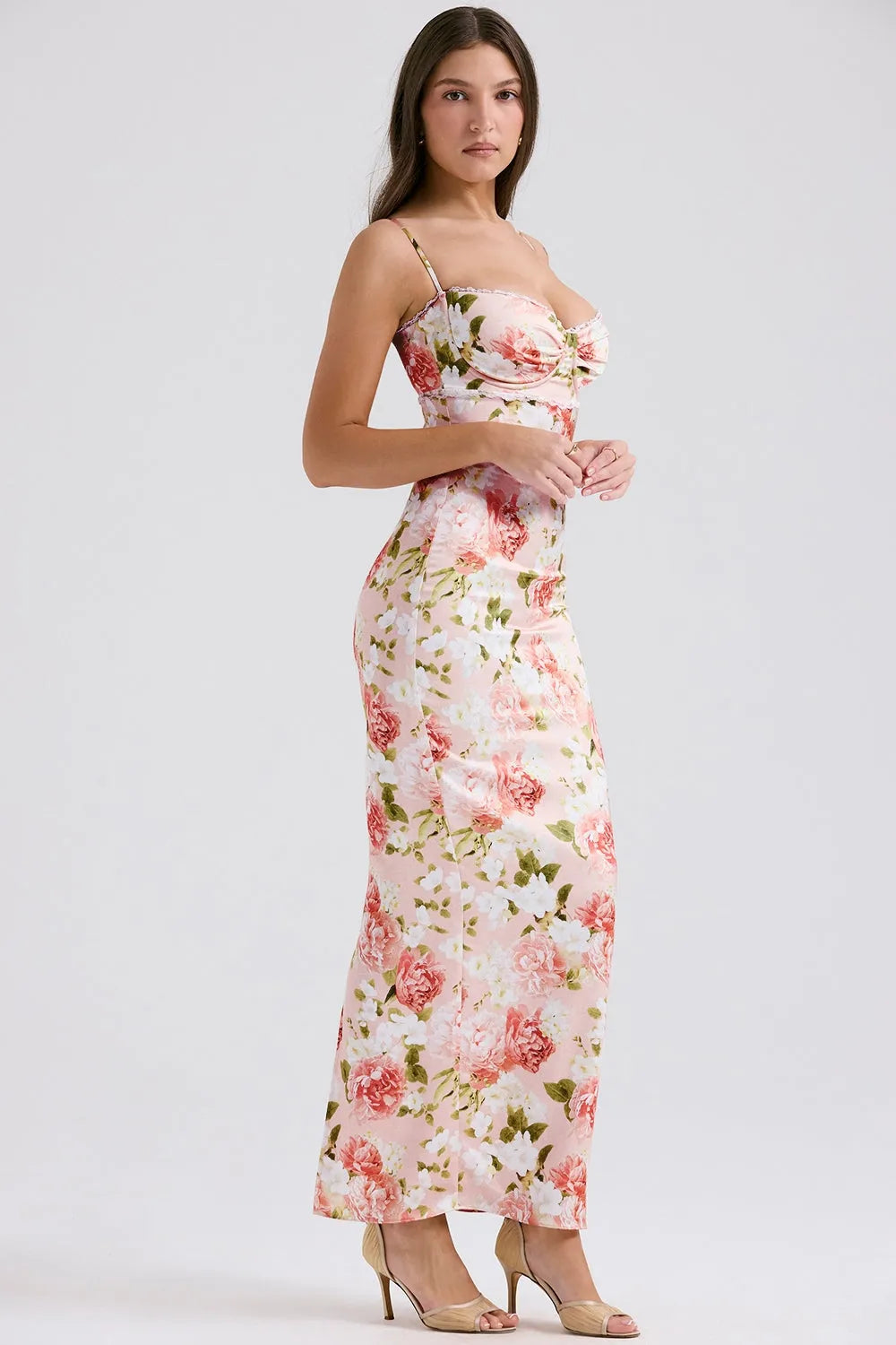 Modelo usando vestido largo floral ajustado al cuerpo con tirantes finos, ideal para fiestas y bodas.